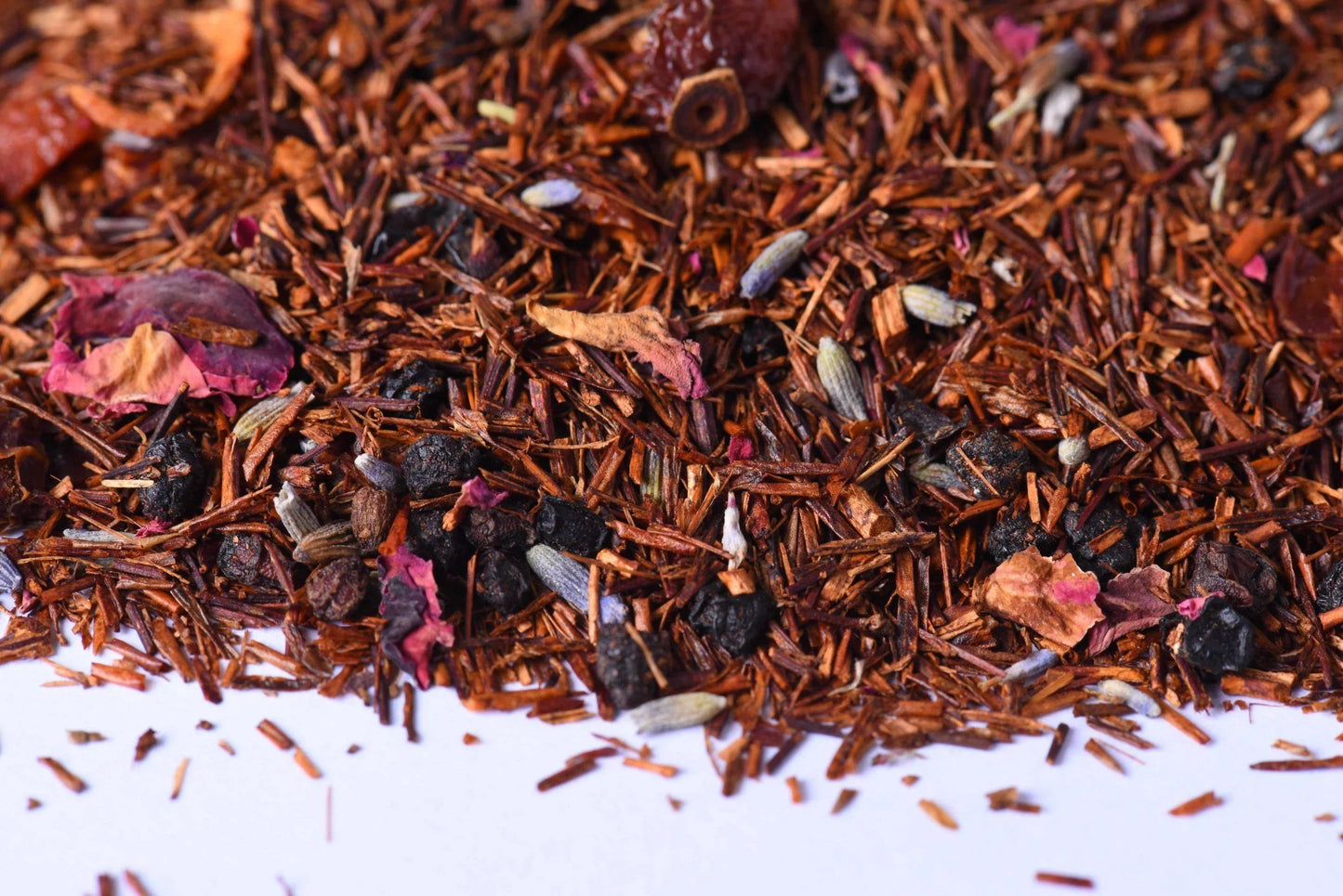 Loose-leaf rooibos herbal tea blend with dried berries, petals, and spices