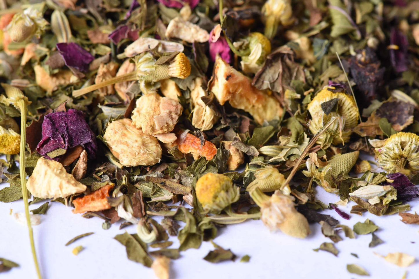 Loose-leaf herbal tea blend with dried chamomile, fruit, and flower petals