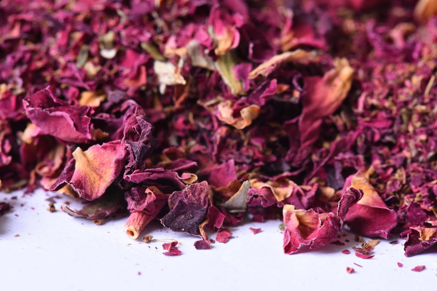Loose dried rose petals for tea or spice blend on a white background