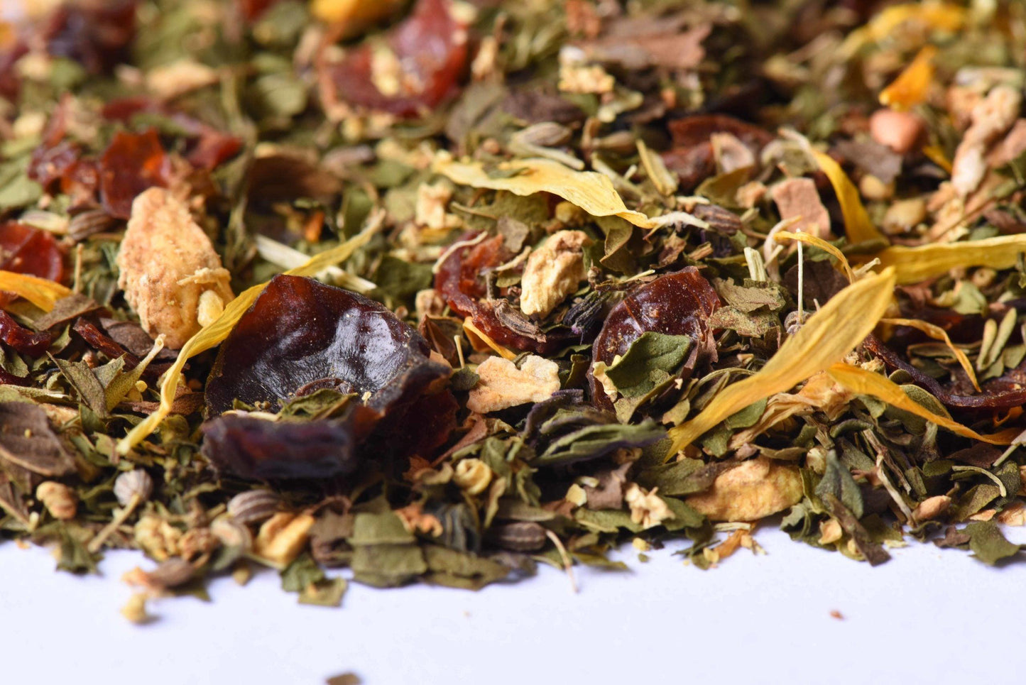 Loose leaf herbal tea blend with dried fruit, herbs, and petals close-up
