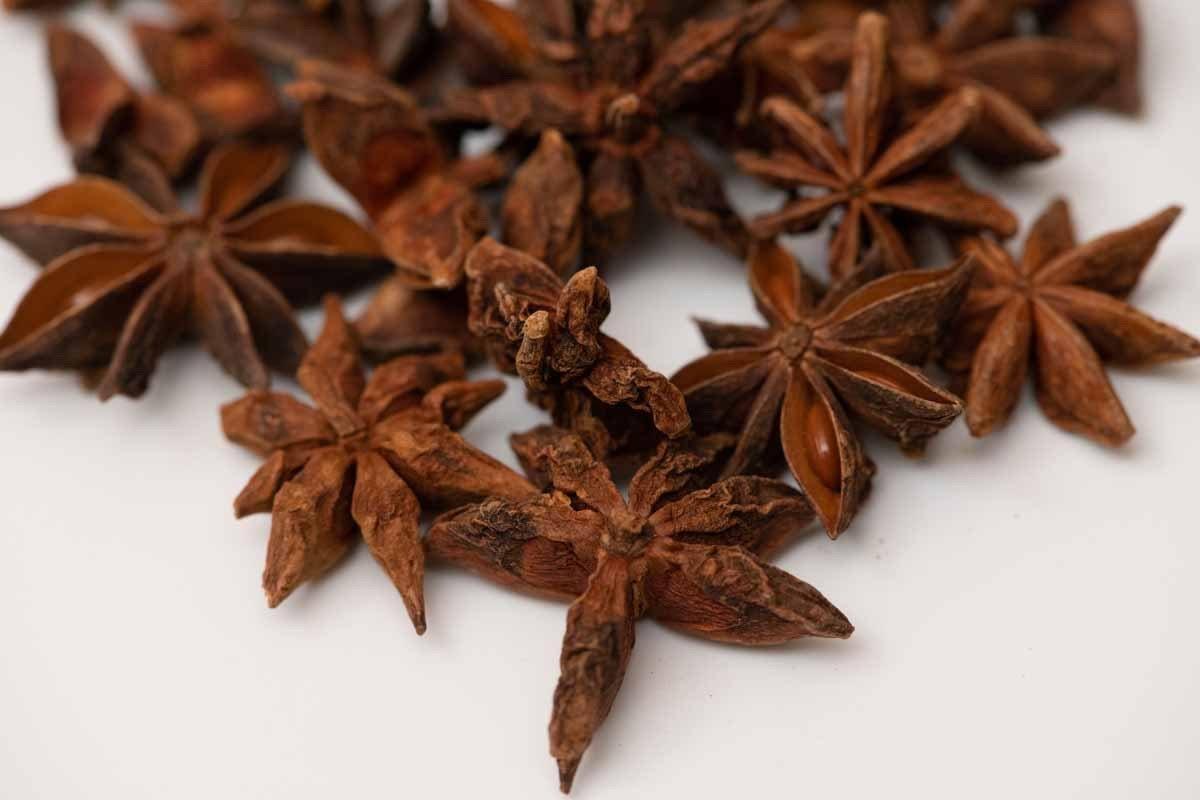 Whole dried star anise spice on white background, aromatic for cooking and tea blends