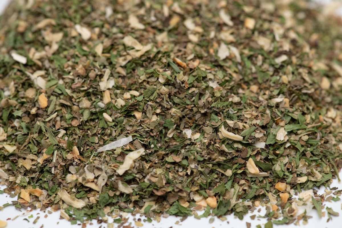 Close-up of dried herb and spice blend mix, showing chopped green and white pieces