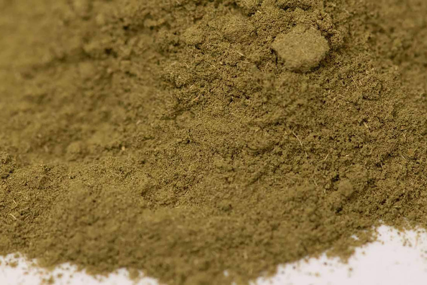 Close-up of finely ground green herb powder, gourmet spice blend for cooking