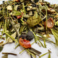 Assorted dried herbs and leaves on a white background