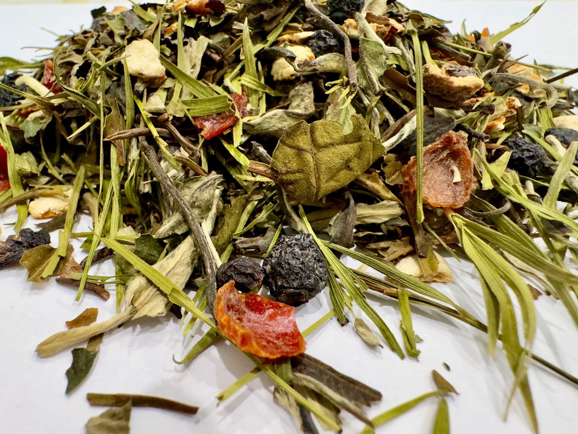 Assorted dried herbs and leaves on a white background