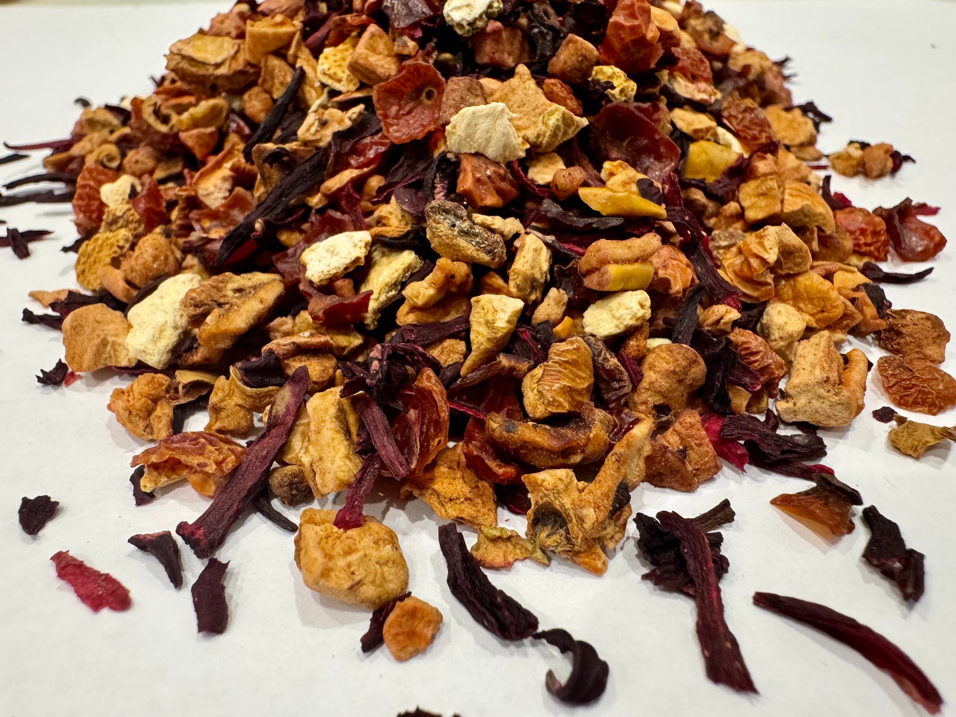 Assorted dried tea leaves on a white background
