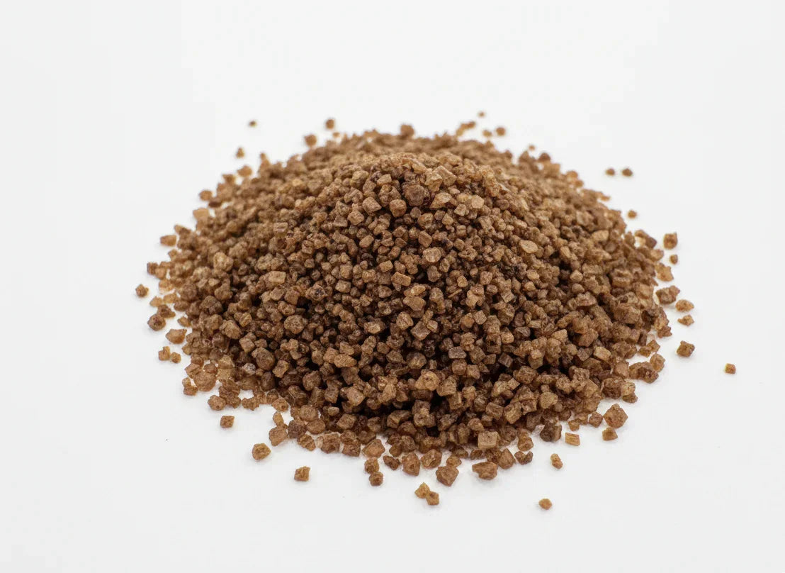 Brown granular salt on a white background
