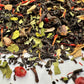 Assorted loose leaf tea with visible spices on a white background