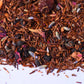 Loose-leaf rooibos herbal tea blend with dried berries, petals, and spices