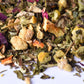 Loose-leaf herbal tea blend with dried chamomile, fruit, and flower petals
