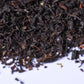 Loose-leaf black tea leaves close-up on white background