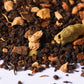 Loose-leaf chai tea blend with black tea, cardamom pods, cinnamon, and ginger pieces