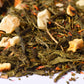 Loose-leaf green tea blend with dried fruit pieces and colorful botanicals