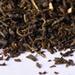 Close-up of loose leaf black tea blend on white background