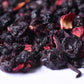 Loose-leaf herbal tea blend with dried berries and hibiscus petals close up