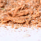 Close-up of gourmet spice blend with herbs and coarse salt on a white surface