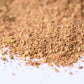 Close-up of blended ground spice mix scattered on a white surface