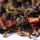 Closeup of loose-leaf gourmet tea blend with dried fruit and herbs