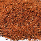 Close-up of a pile of gourmet spice blend with visible herbs and seasonings