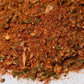 Closeup of gourmet spice blend with herbs and seasonings on a white surface